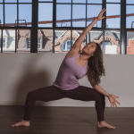 Jung Kim practicing Goddess Pose in a yoga studio