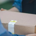 A representational image of a delivery man giving a package. — Unsplash