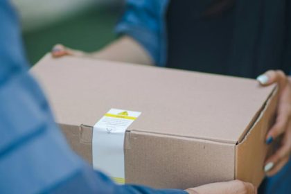 A representational image of a delivery man giving a package. — Unsplash