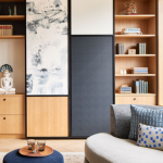 A modern living room with a cream barrel ceiling and wooden accent wall