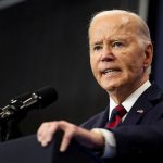 President Joe Biden speaks at a podium.