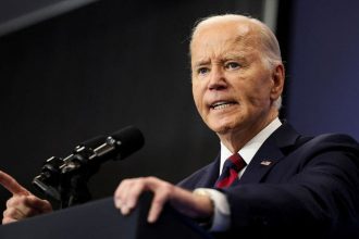 President Joe Biden speaks at a podium.