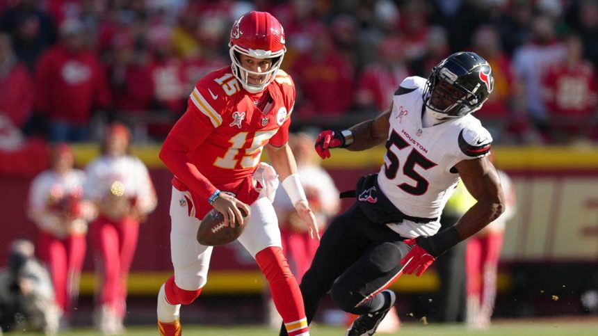 Patrick Mahomes runs past a player