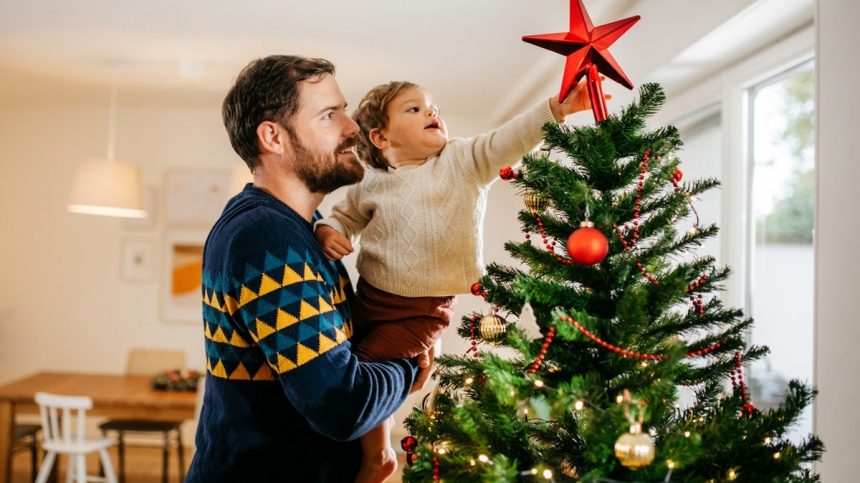 Father and son decorating a Christmas tree