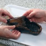 Archaeologist Silke Lange and a co-worker handle a 16th-century Dutch clog, which was found in a cesspool in Alkmaar, at a laboratory in Zaandam, Netherlands, December 20, 2024. — Reuters