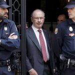 Former International Monetary Fund chief Rodrigo Rato (C) walks between police officers as he leaves his office in Madrid April 17, 2015. — Reuters