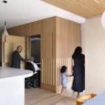 The kitchen features custom millwork that cleverly conceals the elevator.