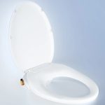 Tushy Wave non-electric bidet seat on a blue and white background