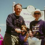 John Ramsey and his family enjoying a vacation and smiling.