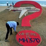 Indian sand artist Sudarsan Pattnaik creates a sand sculpture of the missing Malaysia Airlines flight MH370 on Puri beach in eastern Odisha, India on March 7, 2015. — AFP