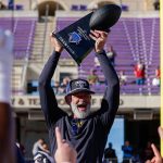 Brian Newberry raises trophy