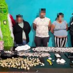 The Grinch posing with suspected drug traffickers.