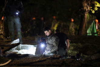 Israeli emergency services work at the scene of a missile strike