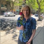 Carol Sbarge holding a flower