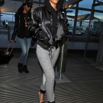 Image may contain Rihanna Clothing Coat Jacket Pants Adult Person Footwear Shoe Hat Accessories and Glasses