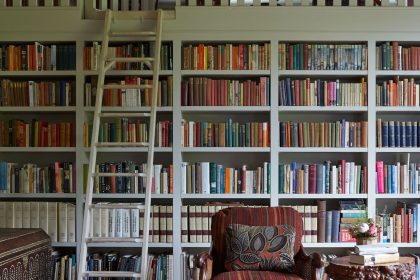 Image may contain Furniture Chair Bookcase Indoors Room Library Book Shelf Living Room and Rug