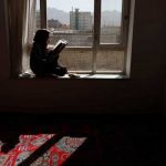 Hawa, 20, a third-year Russian literature student at the Burhanuddin Rabbani University (which was renamed by the Taliban to Kabul Education University), reads a book as she sits on a windowsill at her home in Kabul, Afghanistan, October 23, 2021. — Reuters