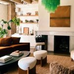 a neutral living room with a bright green murano glass chandelier