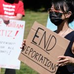 Protesters holding signs take part in a rally to demand the end of deportations in US immigration policy, at Silver Lake Reservoir in Los Angeles, California, US on March 6, 2021. — Reuters