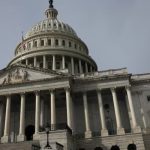 People walk past the US Capitol building as the deadline to avoid partial government shutdown looms in Washington, US, on January 18, 2024. —Reuters