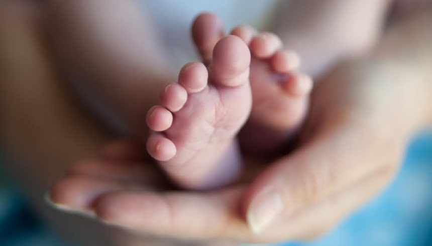 A representational image of a babys feet being held by a woman. — AFP/File