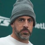 Aaron Rodgers talks to reporters