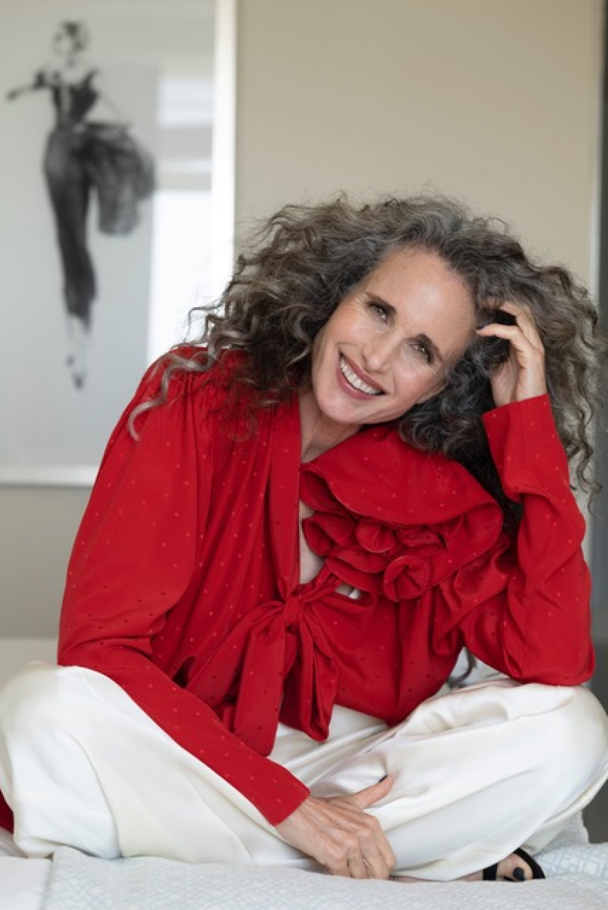 Andie MacDowell curly hair red outfit smile