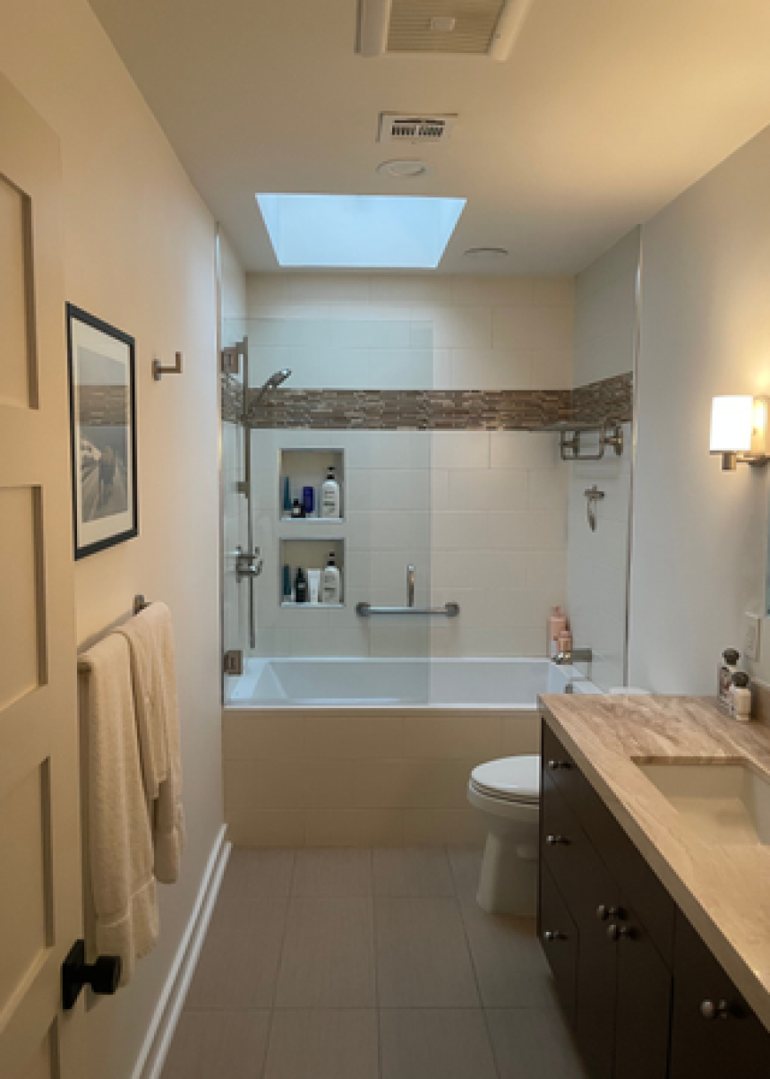 A neutral bathroom with a skylight