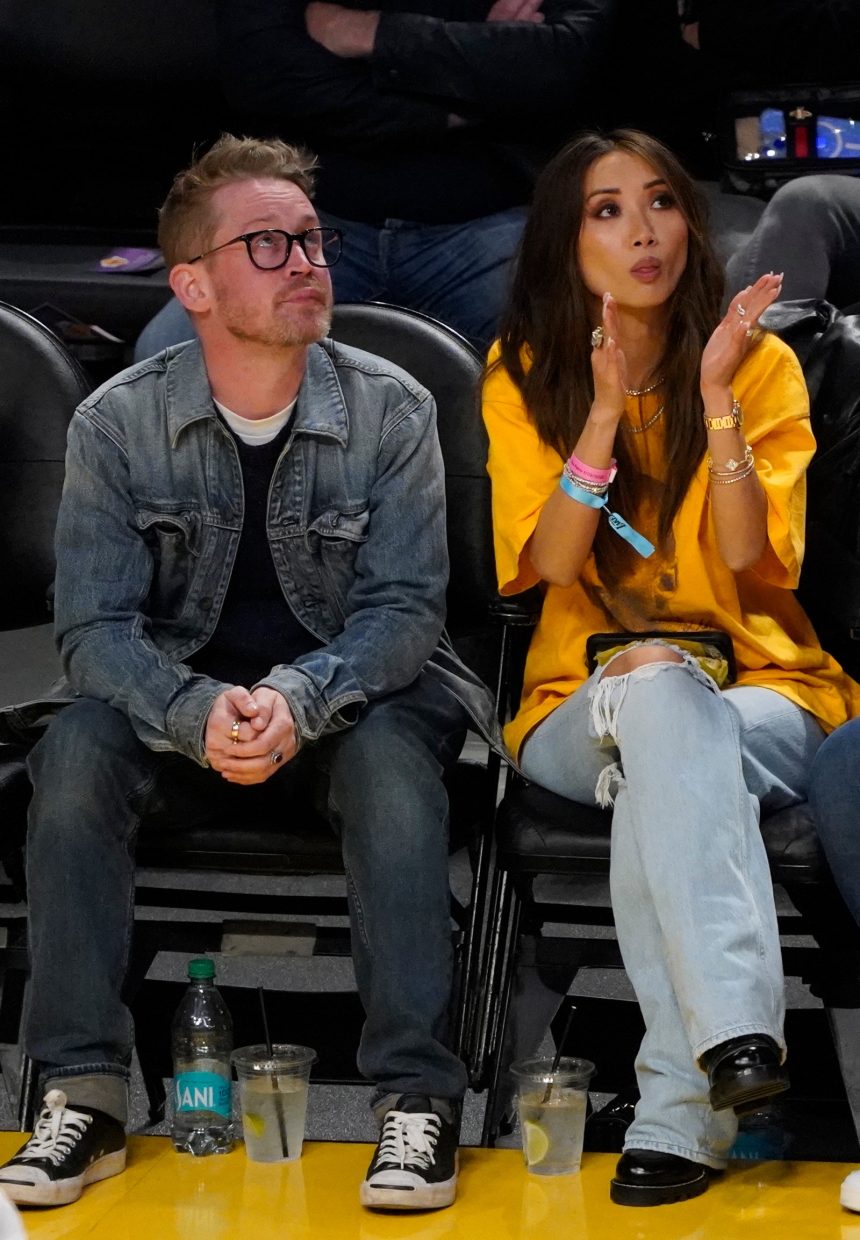 Image may contain Macaulay Culkin Brenda Song Clothing Footwear Shoe Pants Accessories Glasses Cup and Adult