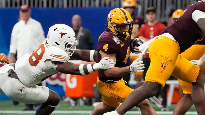 Cam Skattebo escapes a tackle