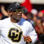 Deion Sanders runs on field