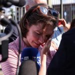 Amanda Knox in a checkered shirt is emotional as she arrives at court flanked by her two male lawyers