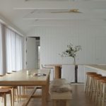 A dining room with white sheer curtains