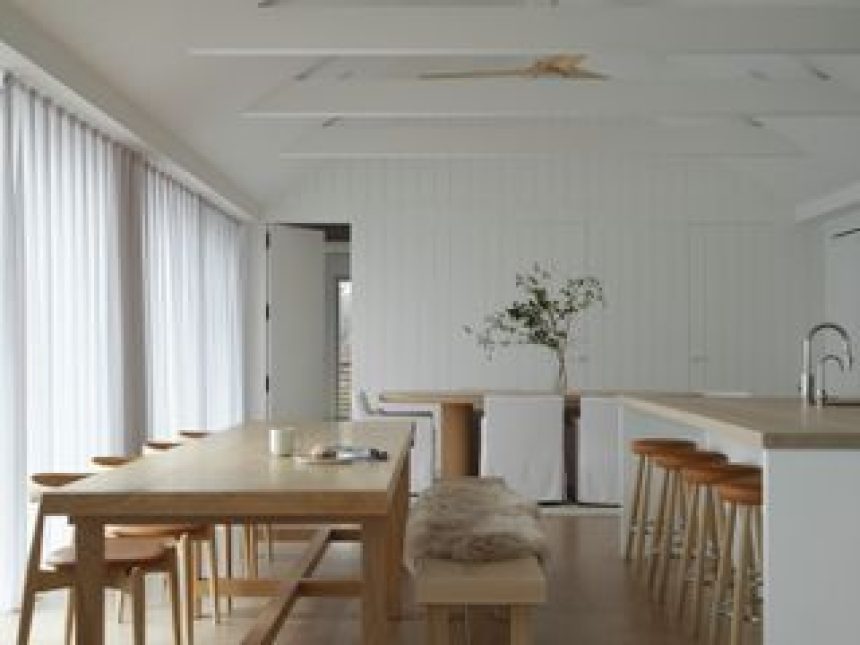 A dining room with white sheer curtains