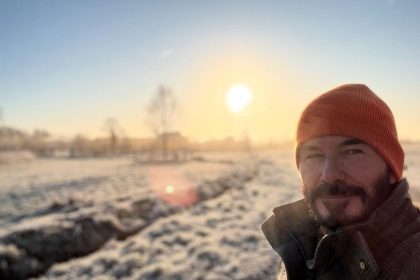 man standing in frosty garden