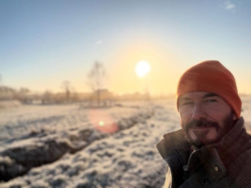 man standing in frosty garden