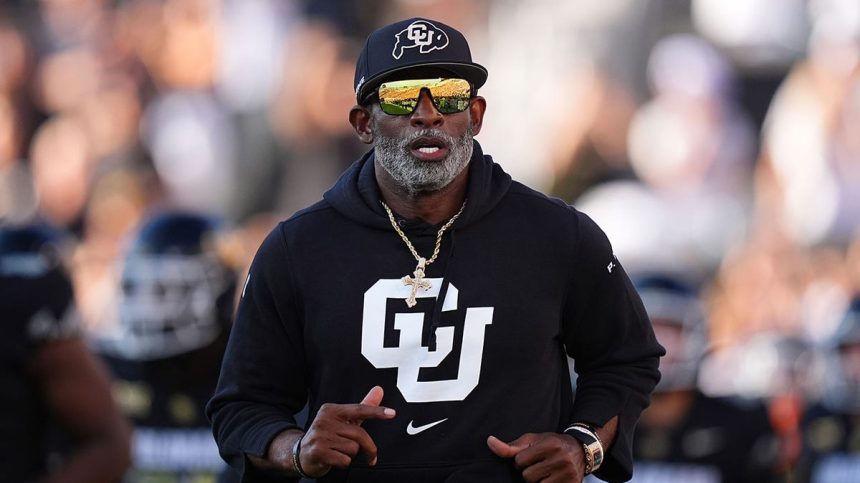 Deion Sanders runs on field