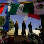 People at a makeshift memorial.