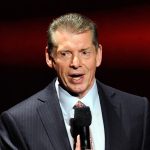 Vince McMahon talks into microphone