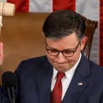 House Speaker Mike Johnson holds up gavel