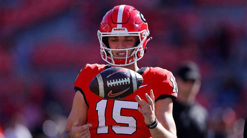 Carson Beck warms up