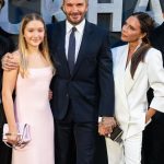 Harper Beckham and David Beckham smile at camera