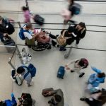 Travelers wait to go through security at San Francisco International Airport (SFO) in San Francisco, California, US, on Monday, Dec. 23, 2024. The Transportation Security Administration (TSA) anticipates screening 40 million passengers this holiday season.