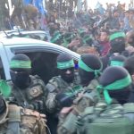 Hamas terrorists emerge in a show of strength escorting Red Cross vehicles carrying three Israeli hostages to be released as part of the cease-fire deal. 