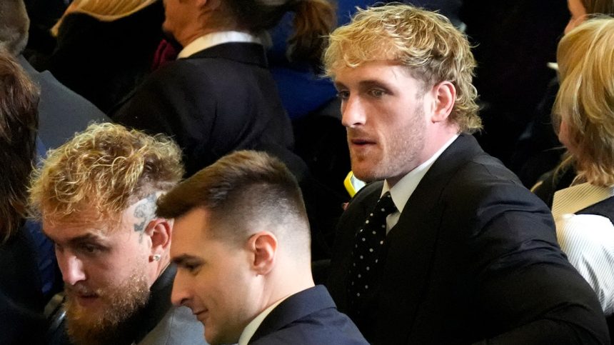 Jake and Logan Paul look to their left inside Emancipation Hall