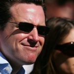 Gavin Newsom smiling next to Kimberly Guilfoyle