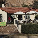 A sign in front of an Altadena home in the California fires says looters will be shot