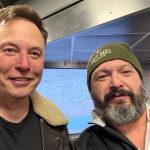 Elon Musk poses with Grey Bull Rescue volunteers