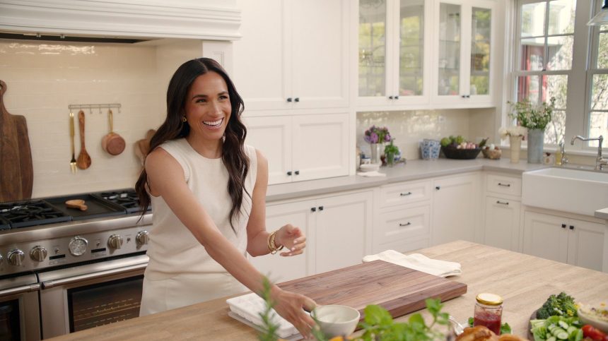 Image may contain Meghan Duchess of Sussex Sink Adult Person Cooktop Indoors Kitchen Chopping Board Food and Blade