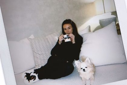 Michelle Keegan cuddled up on the sofa with her dog